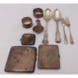 A quantity of hallmarked silver to include two cigarette cases, a vesta case, napkin rings and