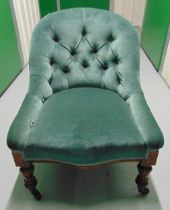 A Victorian upholstered mahogany ladies chair on turned supports with original castors