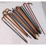 A quantity of walking sticks to include hallmarked silver, white metal and gold mounts (20)