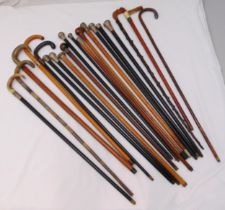A quantity of walking sticks to include hallmarked silver, white metal and gold mounts (20)
