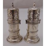 A pair of Victorian hallmarked silver pepperettes, banded cylindrical with pierced bayonet fitted