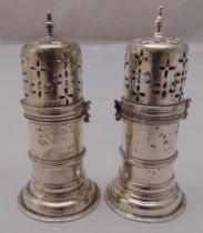 A pair of Victorian hallmarked silver pepperettes, banded cylindrical with pierced bayonet fitted