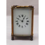 A French brass cased carriage clock of customary form, white enamel dial, to include key, 12cm (h)