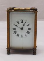 A French brass cased carriage clock of customary form, white enamel dial, to include key, 12cm (h)