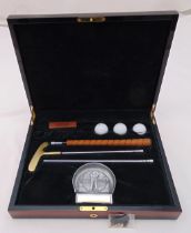 A presentation putter and balls in burr walnut fitted case