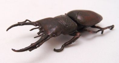 A Japanese Okimono bronze figurine of a stag beetle, 11 x 4.5cm