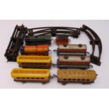 A vintage O gauge litho tin plate wind up train set to include two engines, three coaches, two oil
