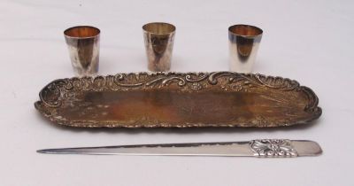 A hallmarked silver pin tray, a hallmarked silver letter opener and three white metal cups