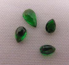 Four cut and polished green garnets of various size