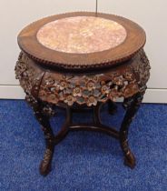 A late 19th century Chinese hardwood and marble circular occasional table carved with prunus blossom