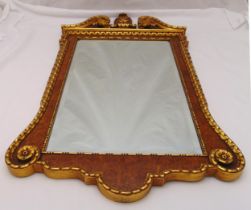 A Georgian style gilt and burr wood framed shaped rectangular bevelled wall mirror with carved