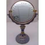 A gilded metal and champlevé dressing table mirror, the raised circular base decorated with stylised