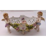 A continental oval pierced ceramic centre piece decorated with applied putti, flowers and leaves, 16