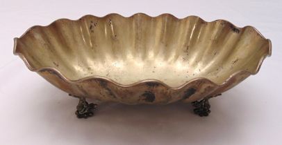 A white metal shell shaped dish on four stylised fish feet, 11.5 x 27 x 35cm