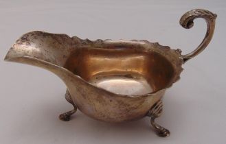 A hallmarked silver sauce boat with cut edge and flying scroll handle, Birmingham 1927, approx total