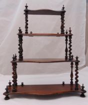 A Victorian graduated four tier mahogany whatnot with barley twist supports and turned circular