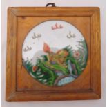A Chinese famile verte Kylin porcelain plaque mounted in a square wooden frame, 24 x 24cm