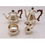 A hallmarked silver four piece tea and coffee set of compressed circular form with scroll handles