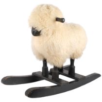 A 1950s Scandinavian rocking horse, in the manner of a sheep, with real wool. L - 67cm.