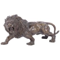 A bronze sculpture of a roaring lion, H15cm, L32cm