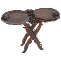 A Japanese carved wooden lily pad table on folding base, early 20th century. W - 61cm, H - 50cm.
