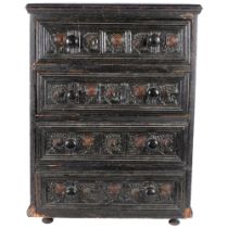 A Victorian ebonised table top chest of 4 drawers, with carved decoration.