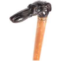 A Malacca cane with carved stylised horn greyhound handle. L - 87cm.
