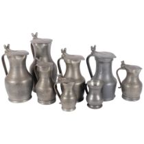 A group of lidded pewter jugs, tallest 26.5cm, and a pewter mug