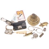 A graduated set of brass weights, a brass pig censer, chrome plated sovereign case, playing cards,