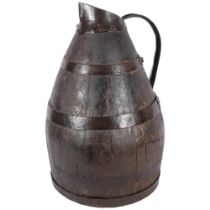 A Continental coopered oak jug with metal bands and handle, H44cm