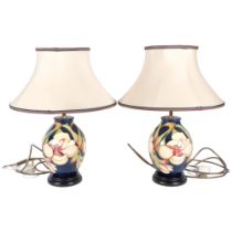 A pair of Moorcroft tube-lined table lamps, with matching shades, designed by Kerry Goodwin, H46cm