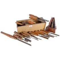 A box of carpentry chisels with turned wood handles, a metronome etc