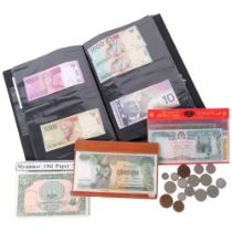 A presentation cased set of 25 Asian bank notes, coins etc including Cambodia, Hungary, Turkey,