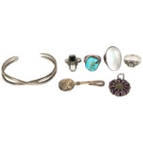 A group of various silver jewellery, including a turquoise set ring, an opal set ring, bangle,