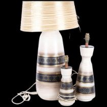 A graduated set of 3, circa 1970s, West German pottery table lamps, with gilded banded decoration,