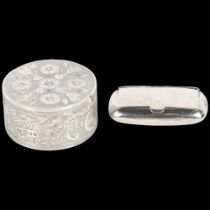 A small ornate scrolled engraved circular silver box and cover, and a rectangular silver pillbox, of