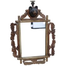 Black Forest carved oak framed wall mirror, with bear's head pediment, H53cm