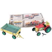 A Zetor wind-up clockwork tin tractor and trailer, made by Kaden in Czechoslovakia, in original box