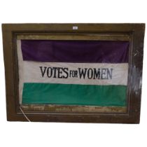 A framed reproduction Suffragette Votes For Women flag in machined cotton, 89cm x 119cm overall