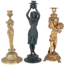 Antique cast-brass candle, supported by the Three Graces, 33cm, an Egyptian style candlestick, and