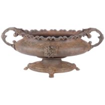 A 19th century French cast iron jardiniere of oval form, with 2 scrolled handles on cast feet. W -