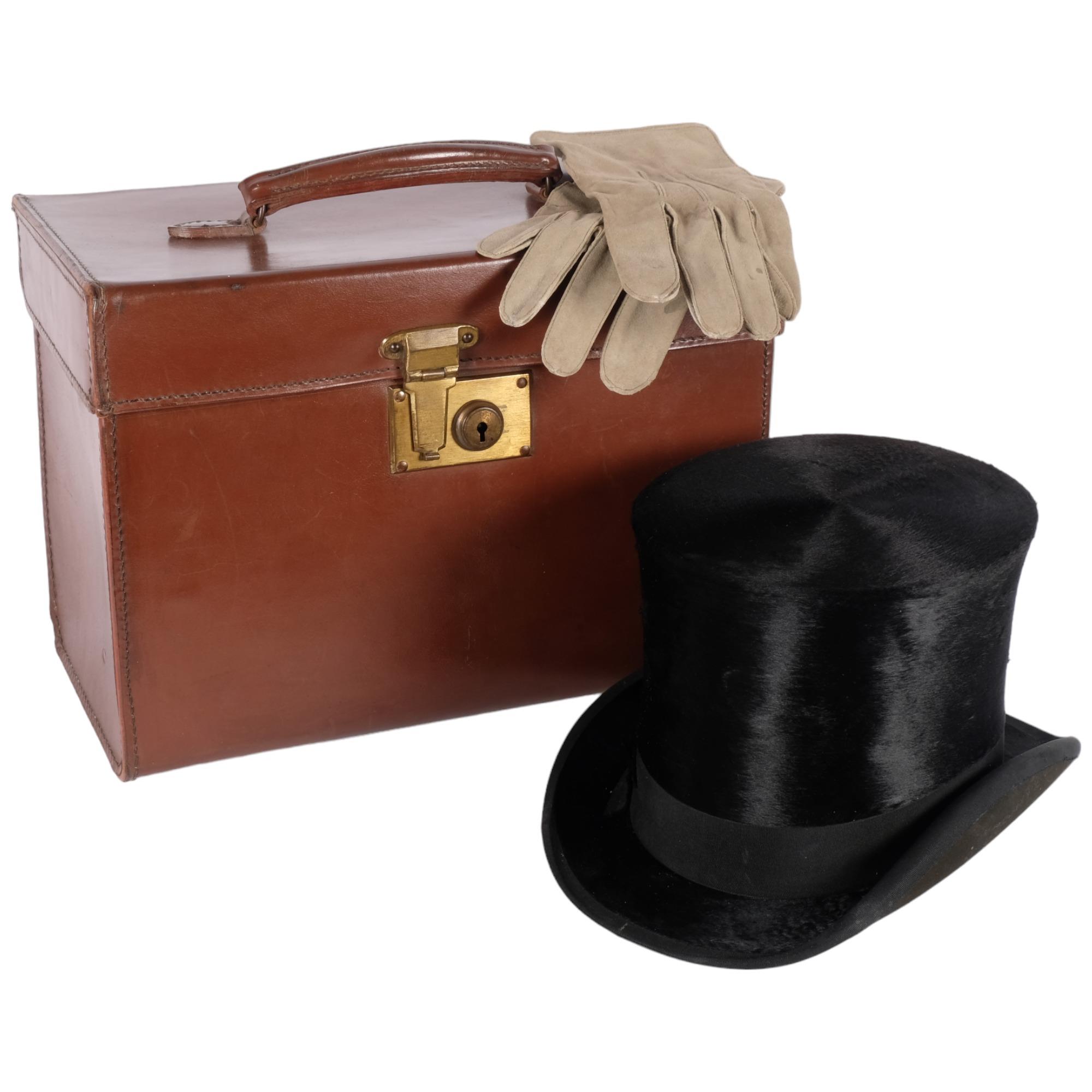 Antique leather hat box with brass lock, containing a top hat by Cockayne of Sheffield, size 6 and