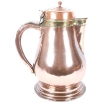 A large antique copper lidded beer jug with brass mount, banding and inscription. H - 35cm.