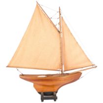 A scratch-built wooden pond yacht, on stand, with sails, H75cm