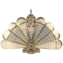 A Victorian ornate pierced brass peacock fan firescreen on cast base. H - 68cm.