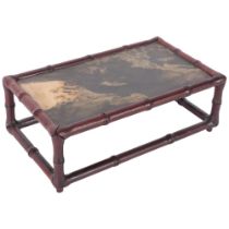 An Oriental faux bamboo stand with inset stone top, 29cm across