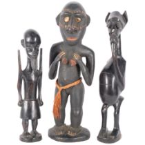 A group of 3 carved hardwood figures, including 2 fertility and another. Largest - 46cm.