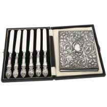 A cased set of silver-handled tea knives, and a notebook with an embossed silver cover