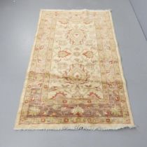 A cream-ground Keshan rug. 177x107cm.