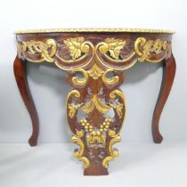 A continental style mahogany demi-lune console table with carved decoration. 101x77x39cm.